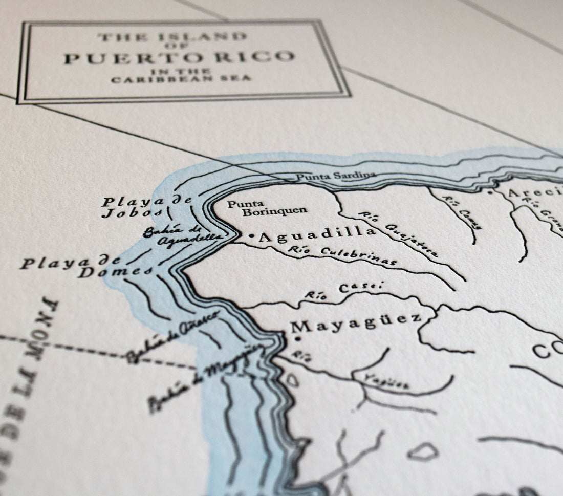 Letterpress print map depicting the Island of Puerto Rico in the Caribbean Sea printed on archival grade cotton paper with watercolor wash along the shorelines